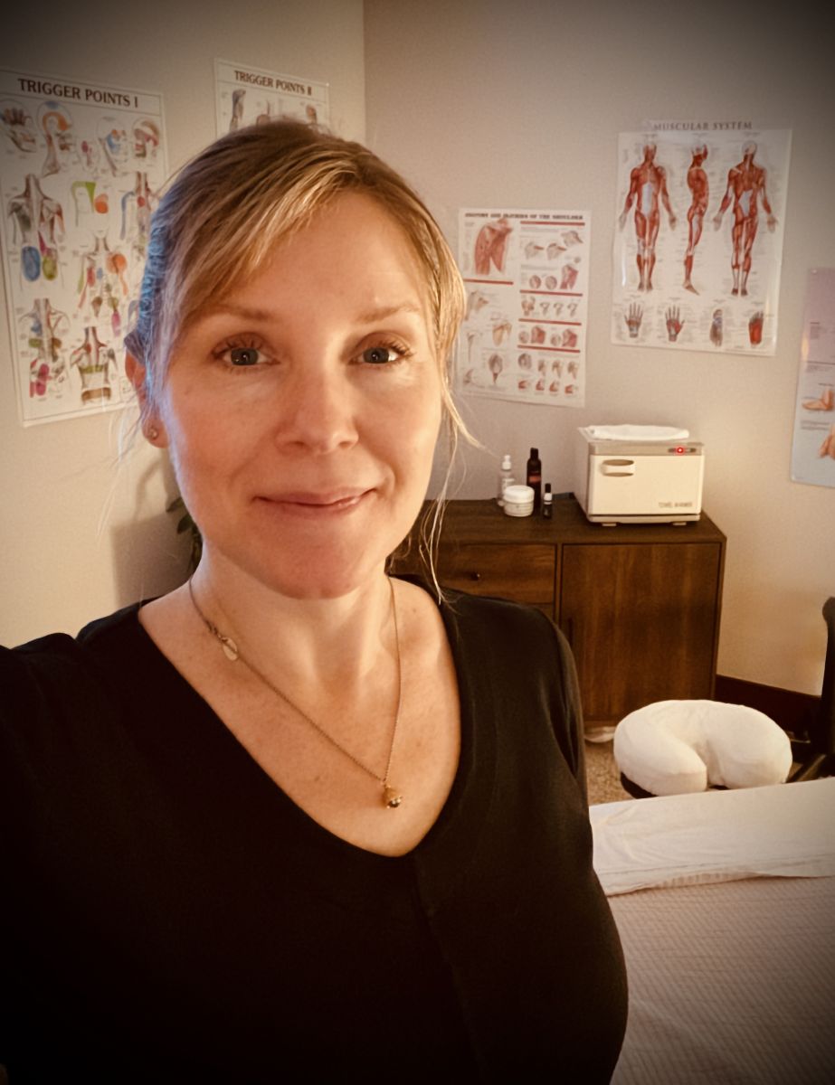 Janelle smiling in her massage room