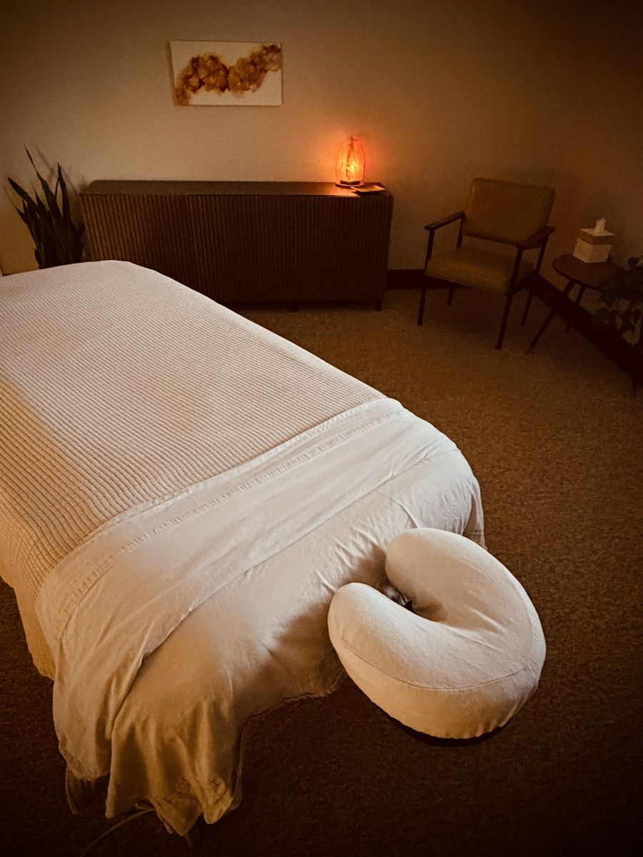 Massage table with wall art in the background