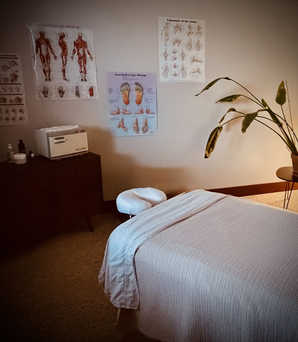Massage table with posters in the background